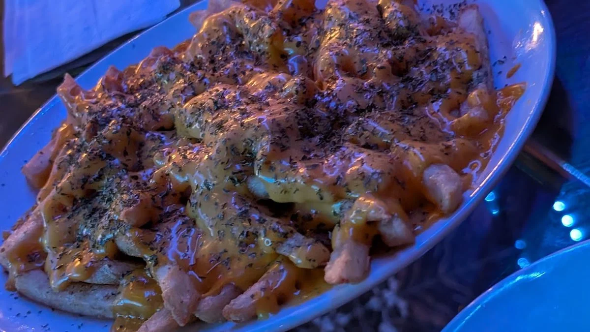 Loaded fries with cheese and herbs