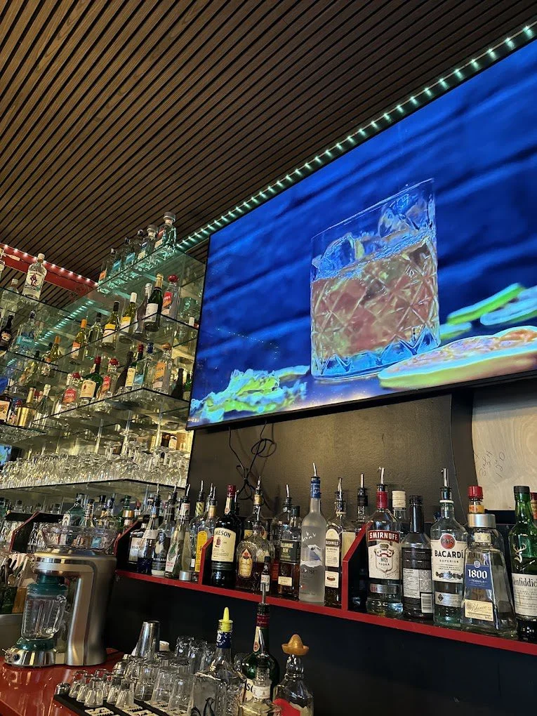 Back bar with spirits and TV screen